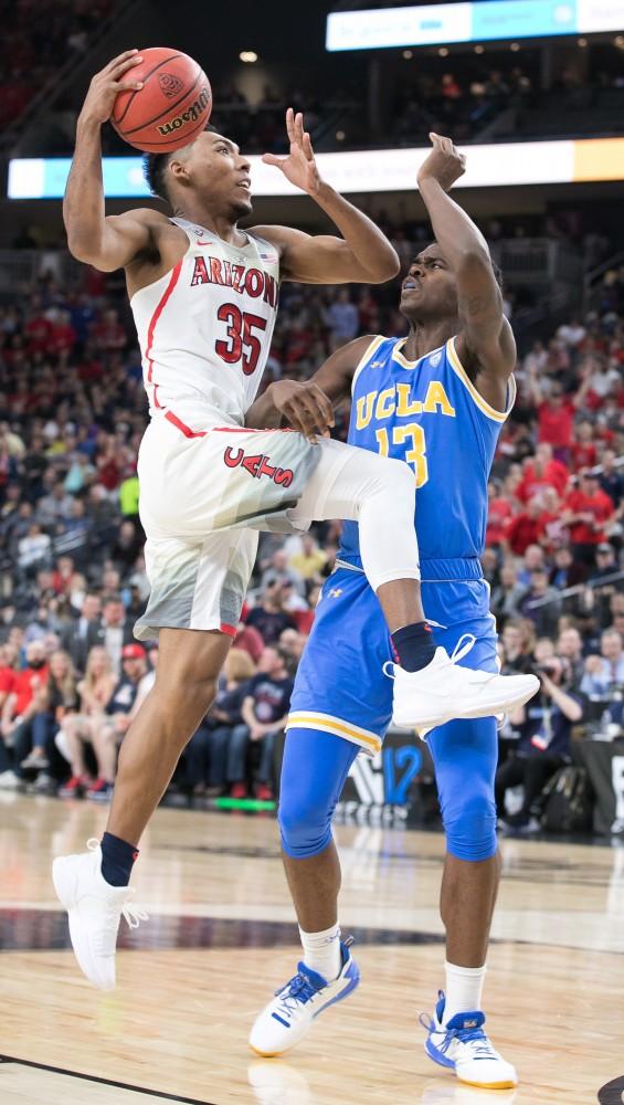 Arizona's Allonzo Trier (35) jumps past UCLA's Kris Wilkes (13) in the second half of the Arizona-UCLA Semifinal game at the 2018 Pac-12 Tournament on Friday, March 9 in T-Mobile Arena in Las Vegas, Nev. Trier finished with nine points and five rebounds.