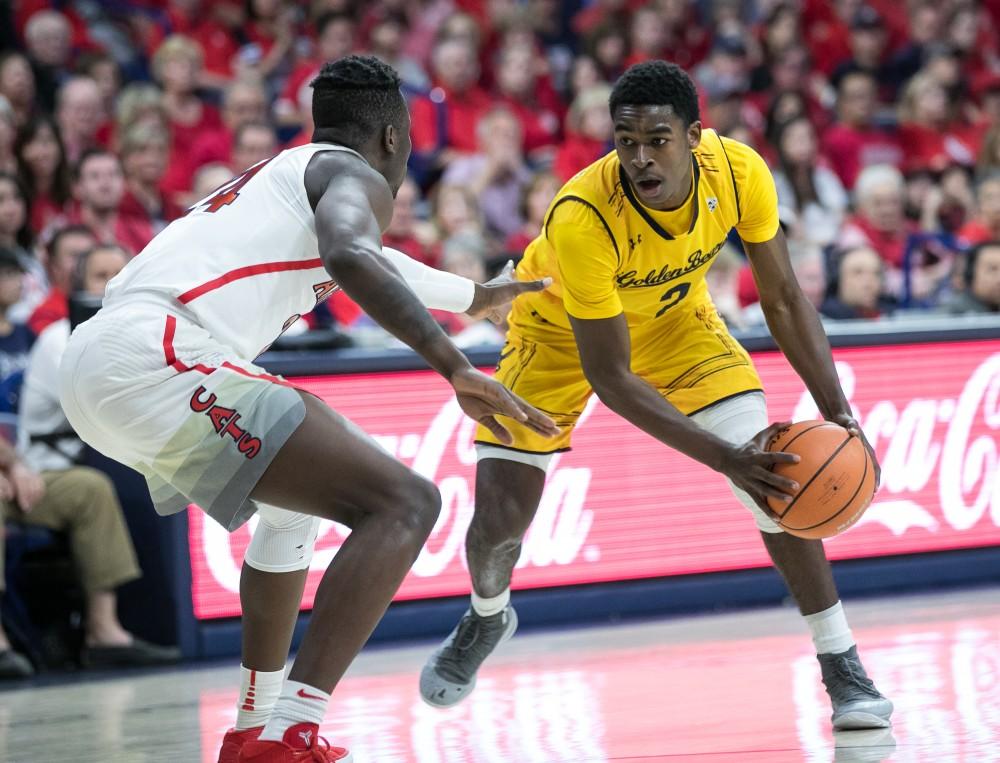 University of California's Juhwan Harris-Dyson (2) looks past Arizona's Emmanuel Akot (24) in the first half of the Arizona-Cal game on Saturday, March 3 in McKale Center.