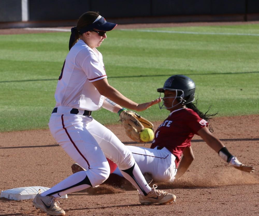 Arizona's Jessie Harper (19) catches an incoming ball to second and gets New Mexico State player out during the Arizona-New Mexico State game at the Rita Hillenbrand Memorial Stadium on Wednesday April 18 in Tucson Ariz.