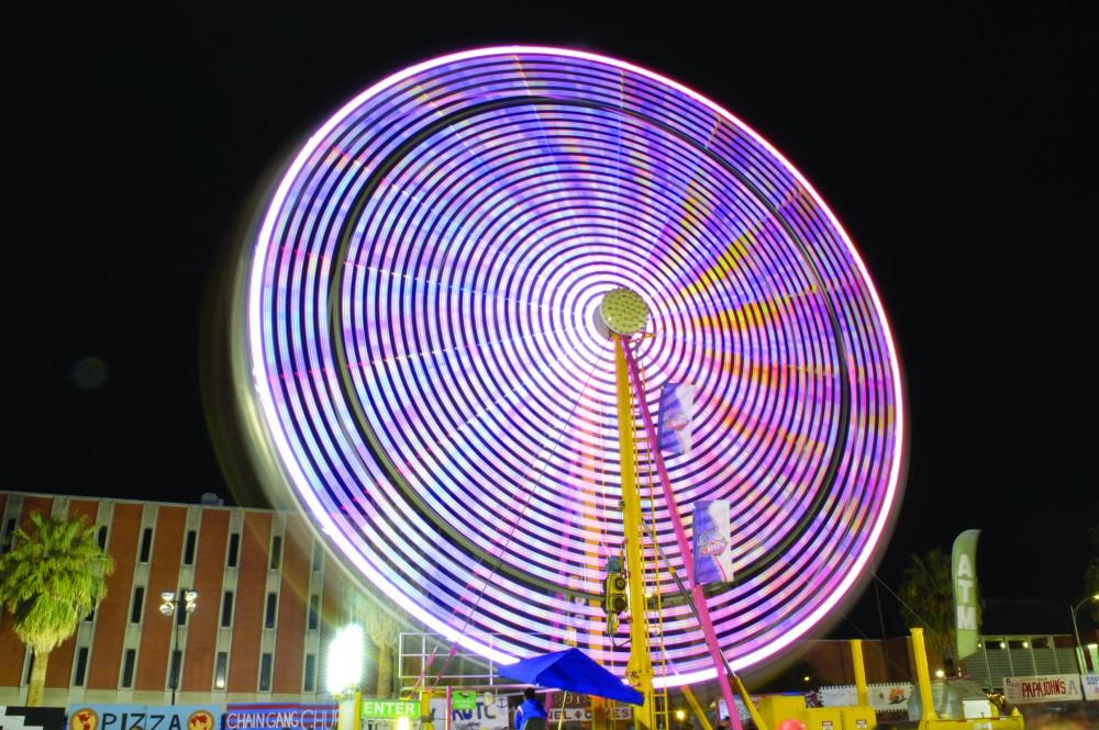 Colors blend together in a long-exposure picture of the Ferris wheel at Spring Fling.