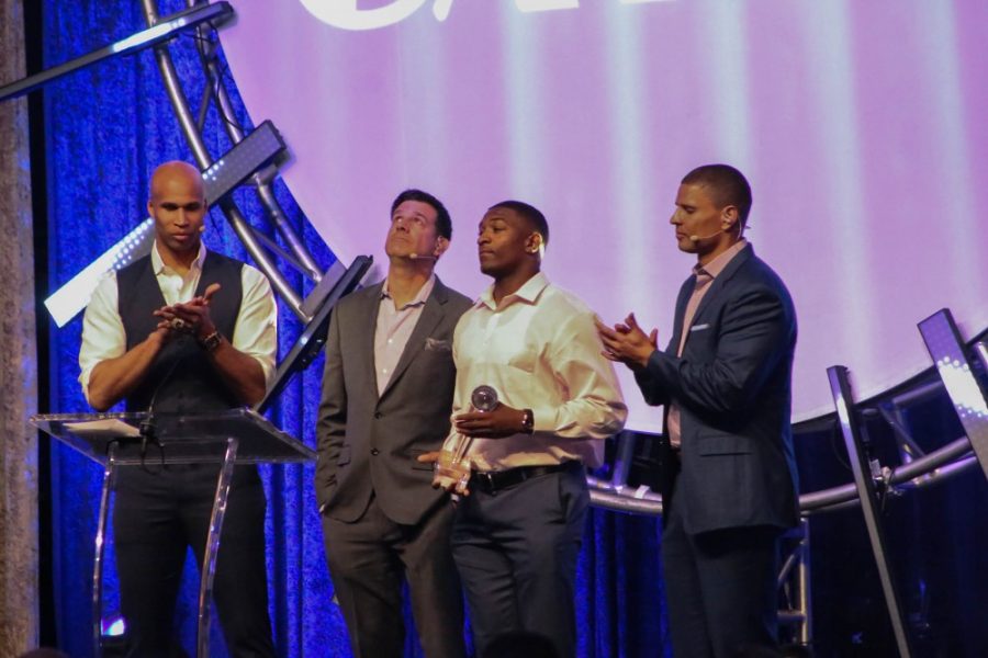 Khalil Tate accepts his award for Sophomore Mae Athlete of the year during the 2018 Catsys Awards on Monday April 16 at the McKale Memorial Center. Hosting the show were Richard Jefferson, left, Chris McGee, middle, and Miles Simon, right.