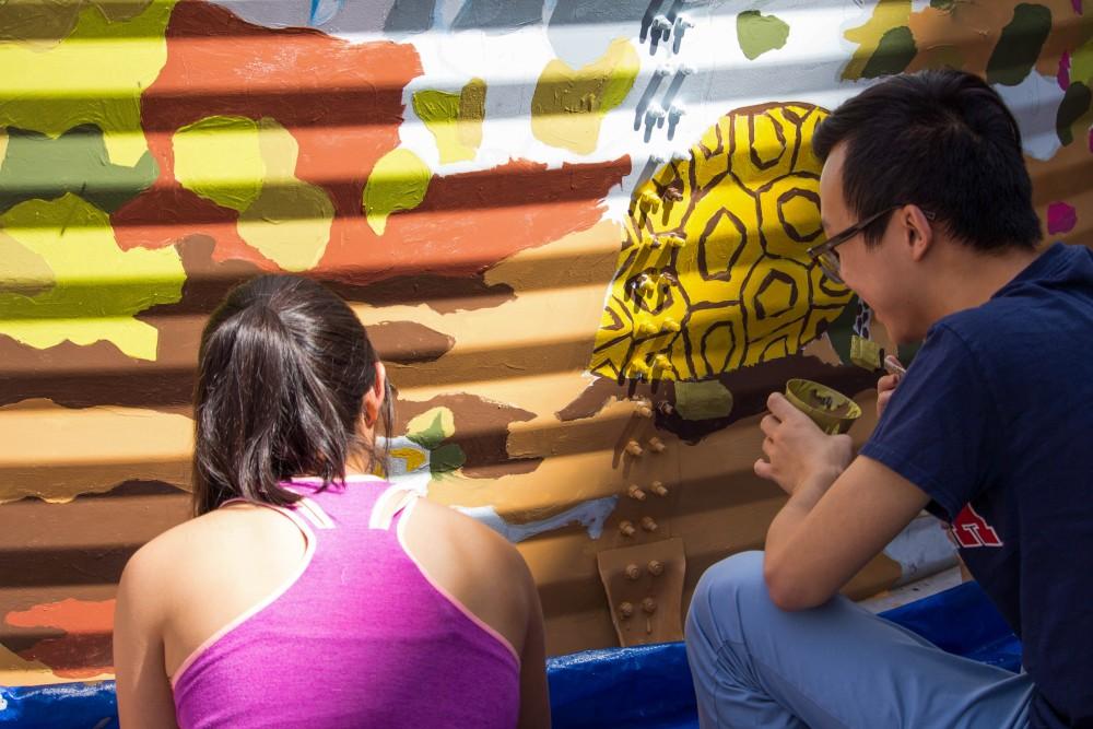 Students for Sustainability painting the mural at the U of A Community Garden on Saturday, March 31, 2018.