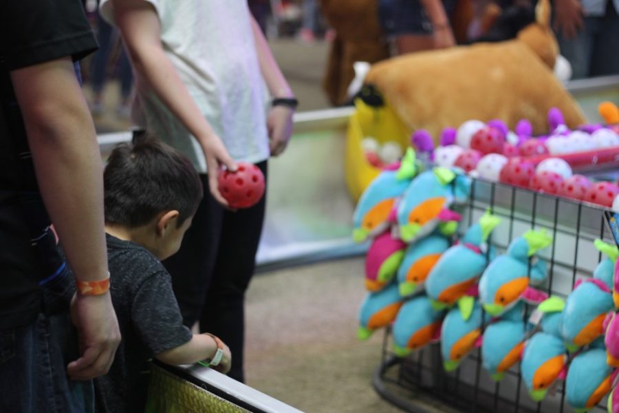 A young child looks eagerly to the prizes at one of the booths during Spring Fling 2017.
