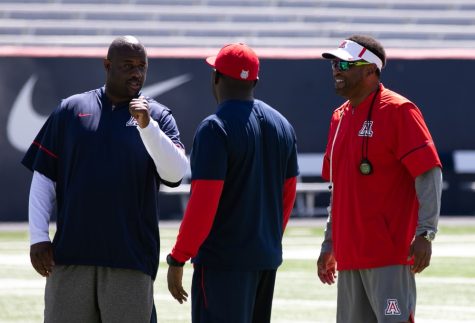 Arizona head football coach Kevin Sumlin watches the UA football team warm up before a scrimmage in the spring football season on Saturday April 7, in Arizona Stadium in Tucson, Ariz.