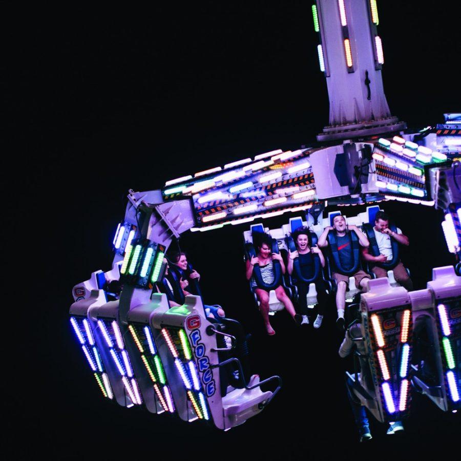 Riders smile as they swing up in the air as they ride G-Force at Spring Fling.