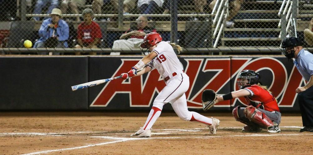 Arizona's Jessie Harper (19) hits a home run during the fourth inning of the Arizona-St. Francis game of the NCAA championship Tournament on Friday May 18 at the Rita Hillenbrand Stadium in Tucson, Ariz. The run scores the cats the first point of the game.