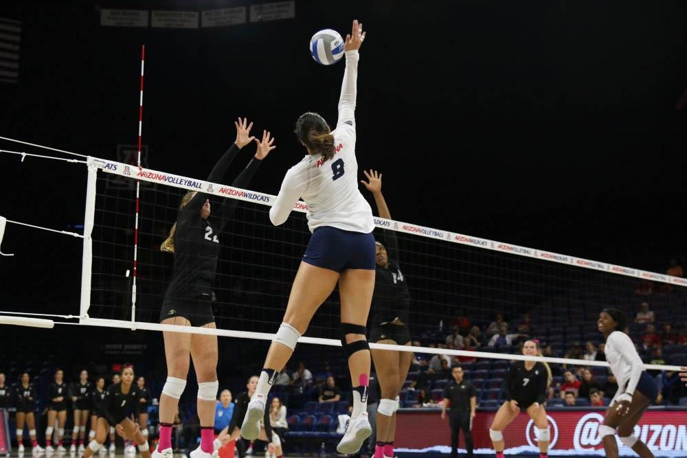 Arizona outside hitter Kendra Dahlke (8) hits the ball over Colorado players on Oct. 15, 2017 in McKale Center.