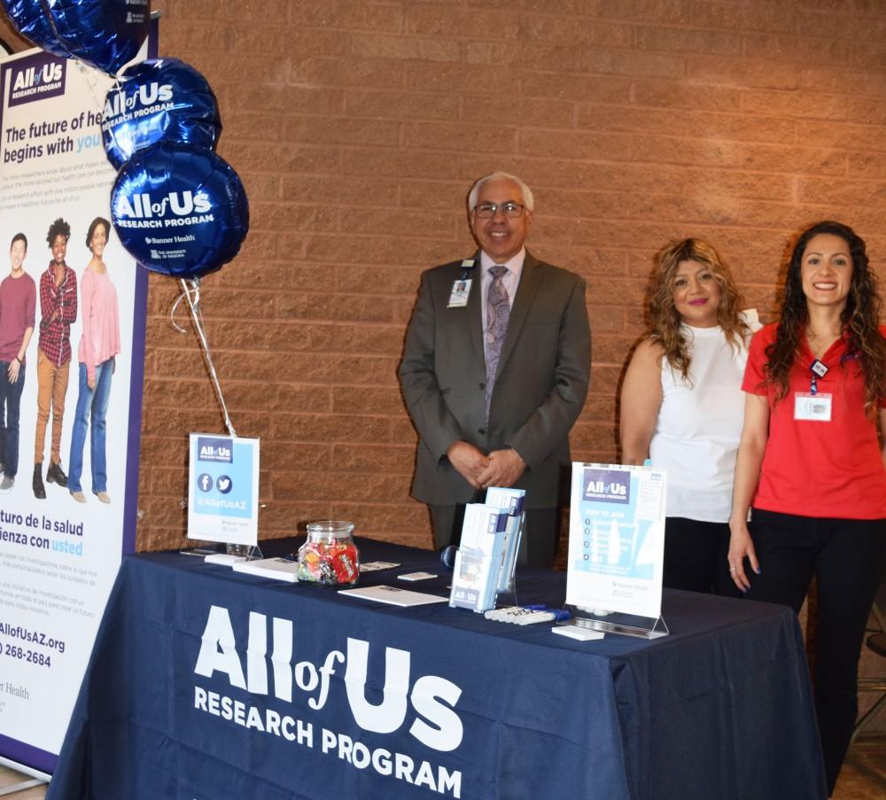 Promotoras for the All of us Research program standing at a booth, from left, Francisco Moreno, MD, Elvia Lopez and Brenda Mora.