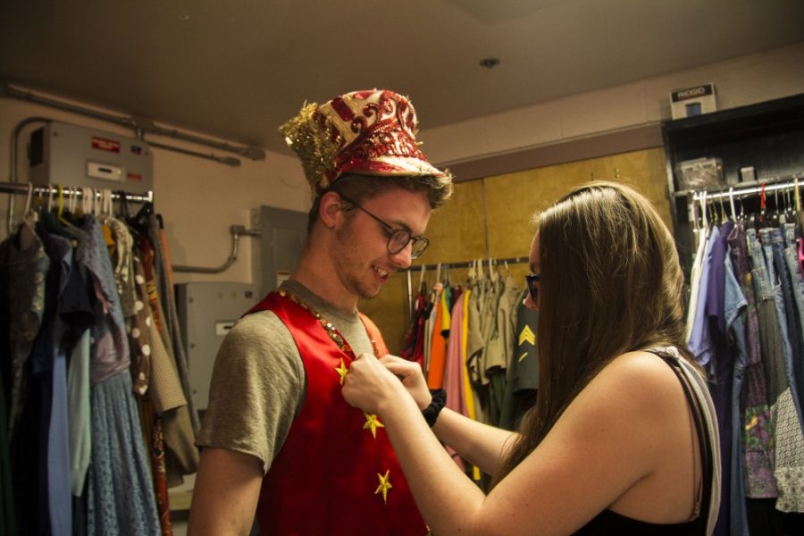 Molly Gluzhinski, Assistant Costume Designer, helps Conner Taylor put on his costume during the rehearsal of Big Fish at Salpointe High School on June 9.   