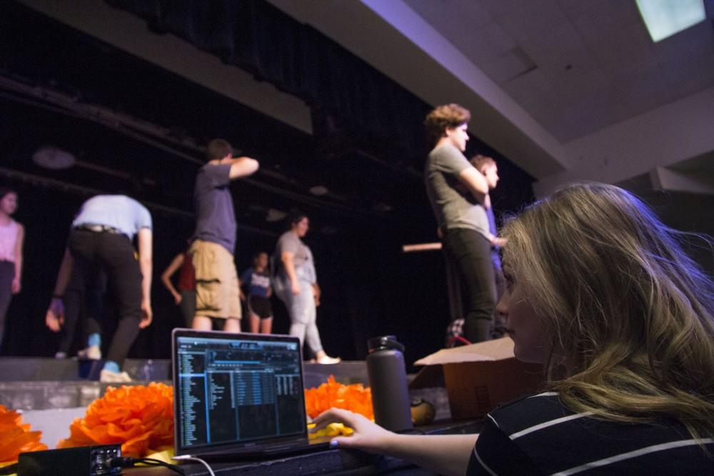 Alizaa Knight, sound technician, controls the music during the Big Fish rehearsal at Salpointe High School on June 9. 