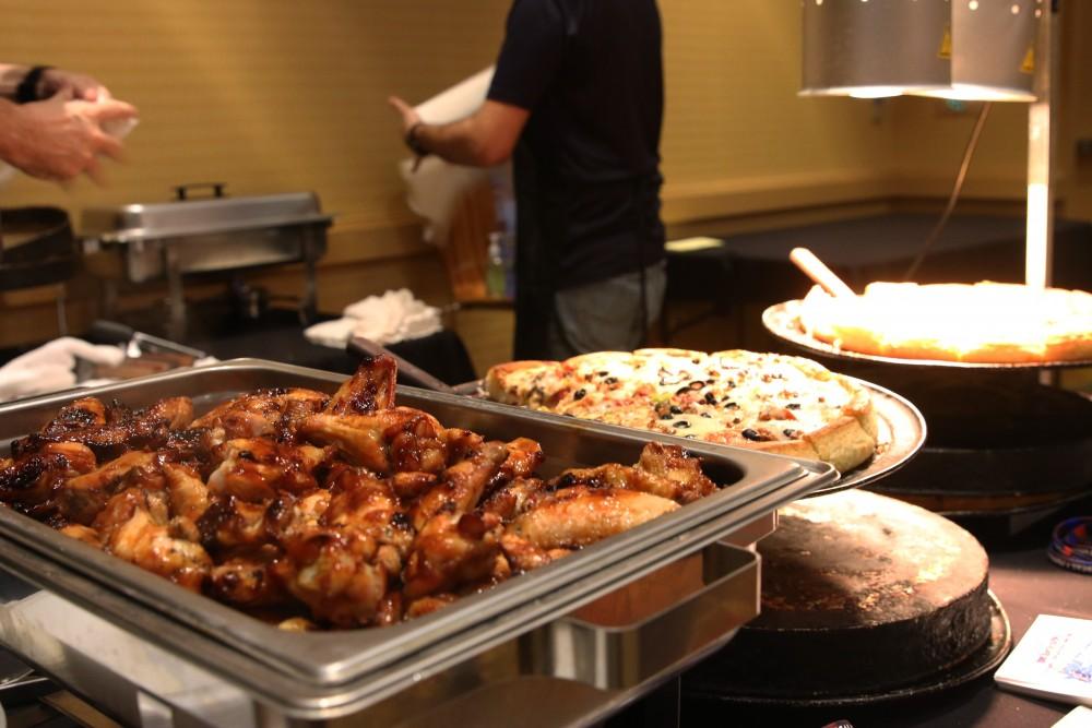 Frog and Firkin serve BBQ chicken wings and pizza to attendees. The restaurant is styled after a British pub, offering food and craft beer on University Boulevard near the UA.