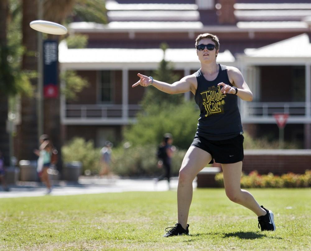 Caroline Schulte, a junior studying biomedical engineering and a member of the women’s ultimate frisbee club team, practices with her teammates on the UA mall on Aug. 21, 2017. 