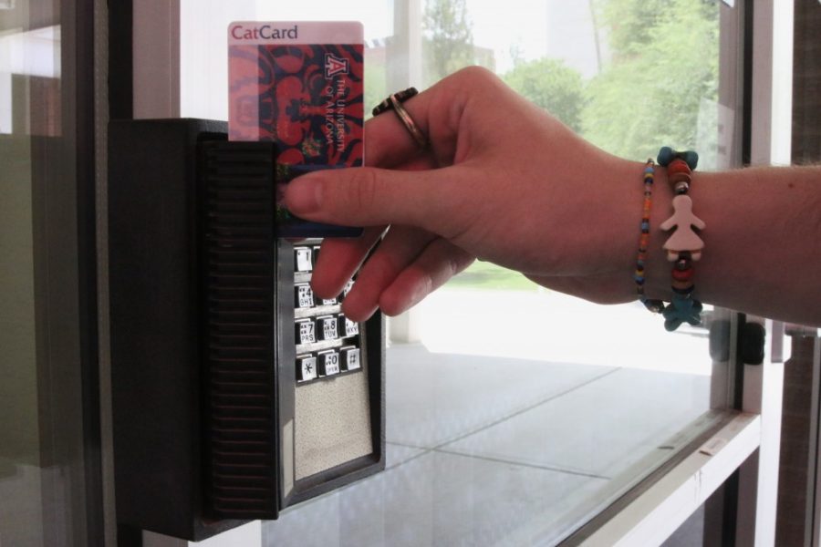 A student uses their Cat Card to enter a building in 2018. The Cat Card can be used to receive discounts at various places.