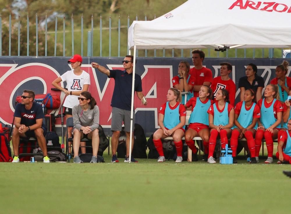 Arizona Women's Soccer head coach, Tony Amato, directs his sitting team to look at a play that is unfolding during the Arizona-Houston Baptist on Sunday, Aug. 26, 2018 at Mulcahy Stadium in Tucson, Ariz.