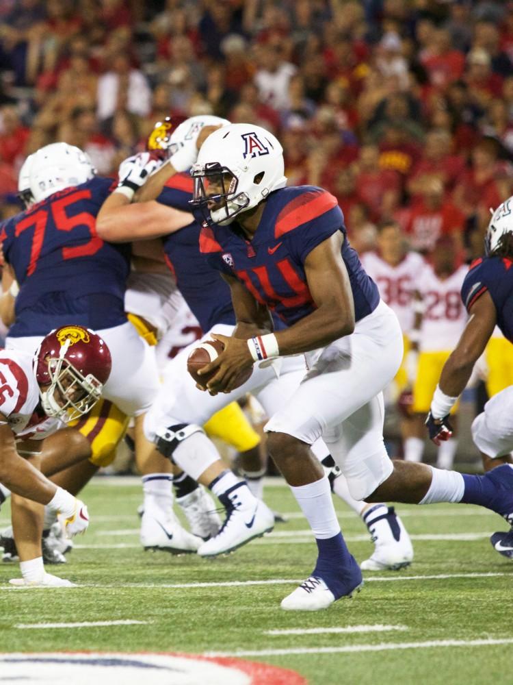 Khalil Tate runs to pass the ball and avoids getting tackled during the UA v USC game on Saturday Sep 29 at Arizona Stadium. USC beat UA 24-20. 