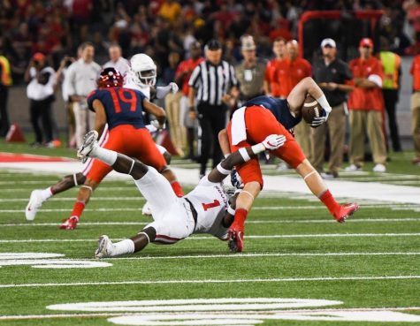 Houston's Garrett Davis (1) takes down an Arizona player during the UA-Houston game on Sept. 9 at Arizona Stadium.