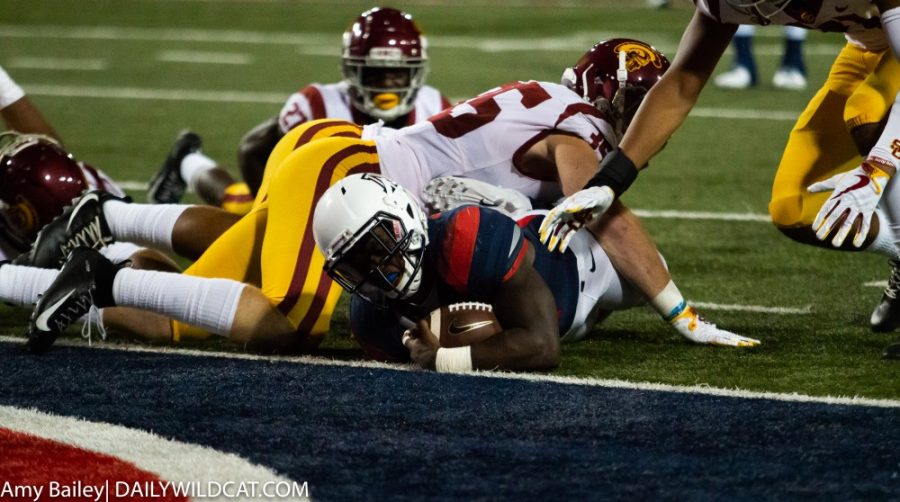 J.J. Taylor (21) gets tackles before reaching the end zone during the last minutes of the Arizona-USC game at the Arizona Stadium on Saturday September 29, 2018 in Tucson, Az.