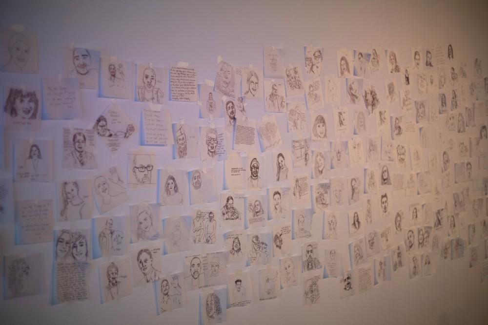 The wall of artwork that was displayed as part of the Memorial for Past and Potential Gun Victims at the Lionel Rombach Gallery. Participants were able to trace faces of submitted photos to show how anyone can be affected by gun violence. 