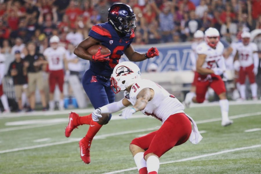 Shun Brown dodges a SUU defender and gets a touchdown for the Wildcats during the 2nd quarter. Arizona defeated Southern Utah 62-31. 