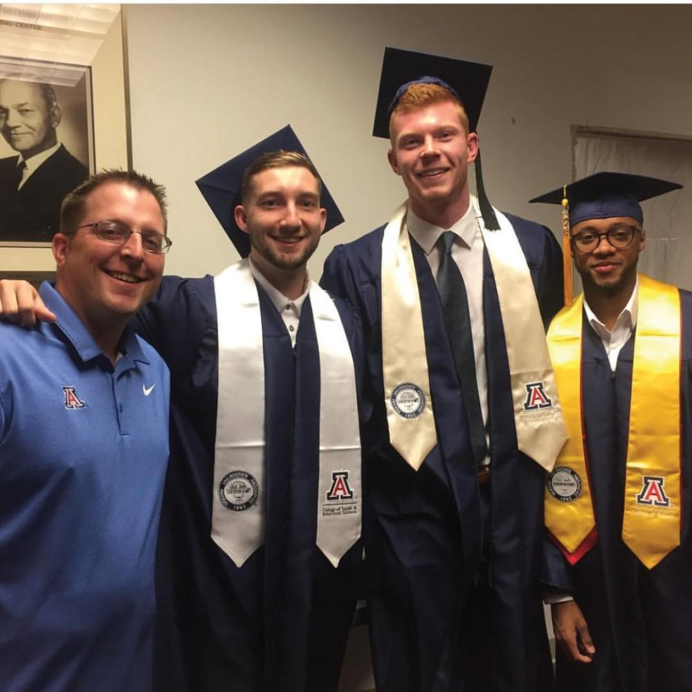 Brian Brigger, far left, poses with former Arizona men’s basketball players Tyler Trillo, left; Talbott Denny, middle, and Parker Jackson-Cartwright, right. Brigger manages equipment for the men’s basketball team.