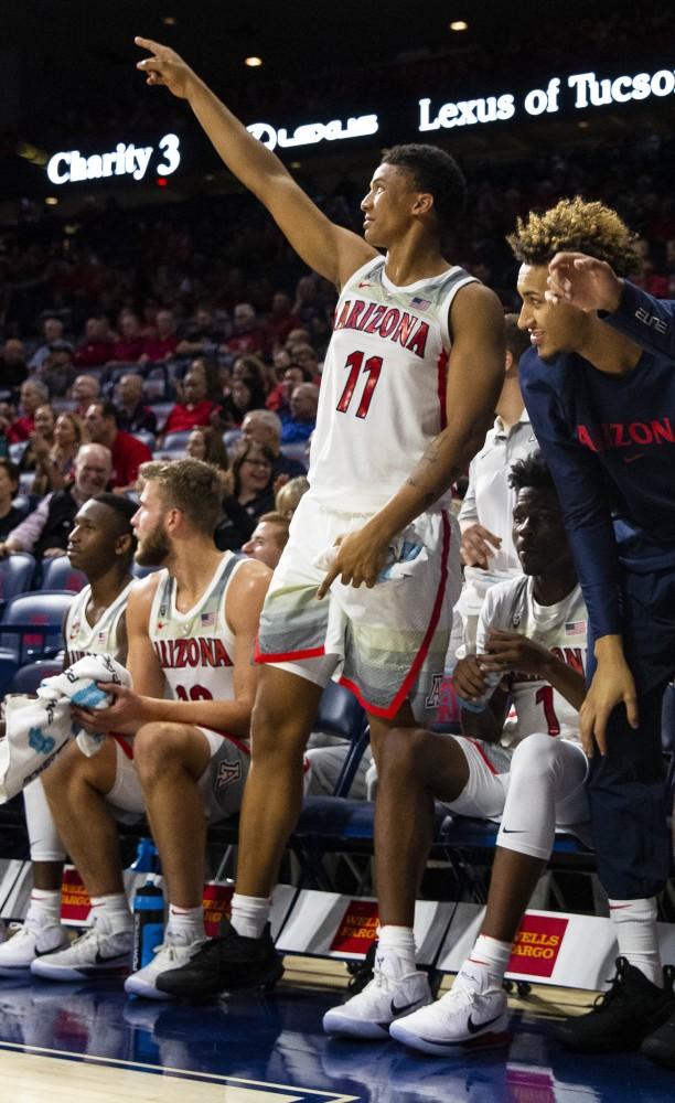 Arizona's Ira Lee, 11, and Chase Jeter, 4, celebrate their teammate's effort during the Arizona-West New Mexico University game on Tuesday, Oct. 30 at the McKale Center in Tucson, Ariz.