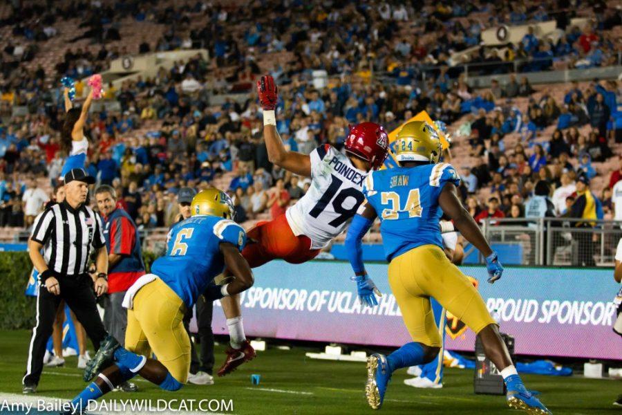 Arizonas wide receiver Shawn Poindexter (19) gets tackled into the end zone during the Arizona-UCLA game at Spieker Field on Oct. 20, 2018 at the Rose Bowl in Pasadena, CA. The final score was UCLA 31 and Arizona 30.