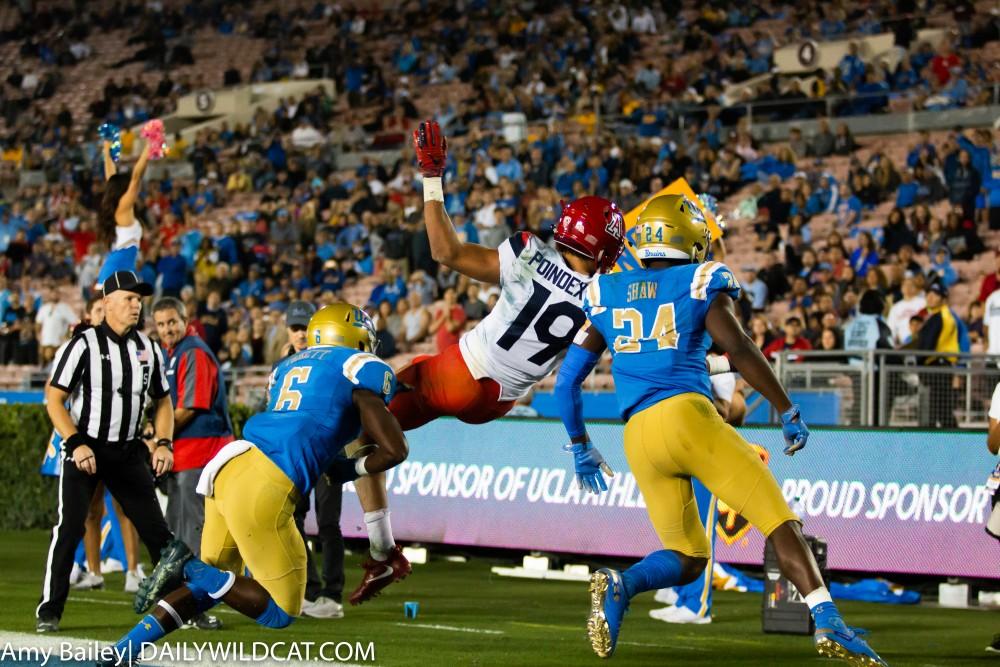 Arizona's wide receiver Shawn Poindexter (19) gets tackled into the end zone during the Arizona-UCLA game at Spieker Field on Oct. 20, 2018 at the Rose Bowl in Pasadena, CA. The final score was UCLA 31 and Arizona 30.