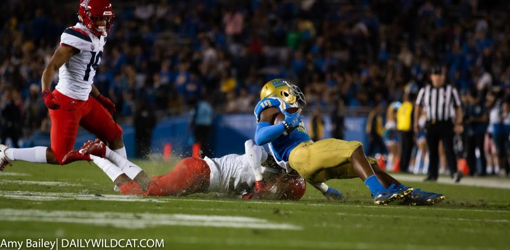 Arizona defensive player attempts to tackle UCLA's runner during the Arizona-UCLA game at Spieker Field on Oct. 20, 2018 at the Rose Bowl in Pasadena, CA.