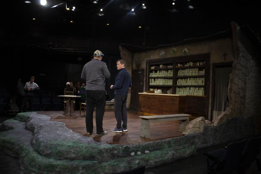 Joe Klug, an assistant professor aiding in design, left, and Hank Stratton, the director of the play, right, discuss the finished set before rehearsals on Thursday, Oct. 25 in the Torabene Theatre in Tucson, Ariz.