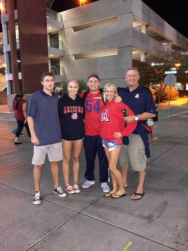 Former Arizona football player Rob Kleifield (54) takes a pictures with his family after a game.  Kleifield's family has been instrumental in his on-going journey with the game of football.