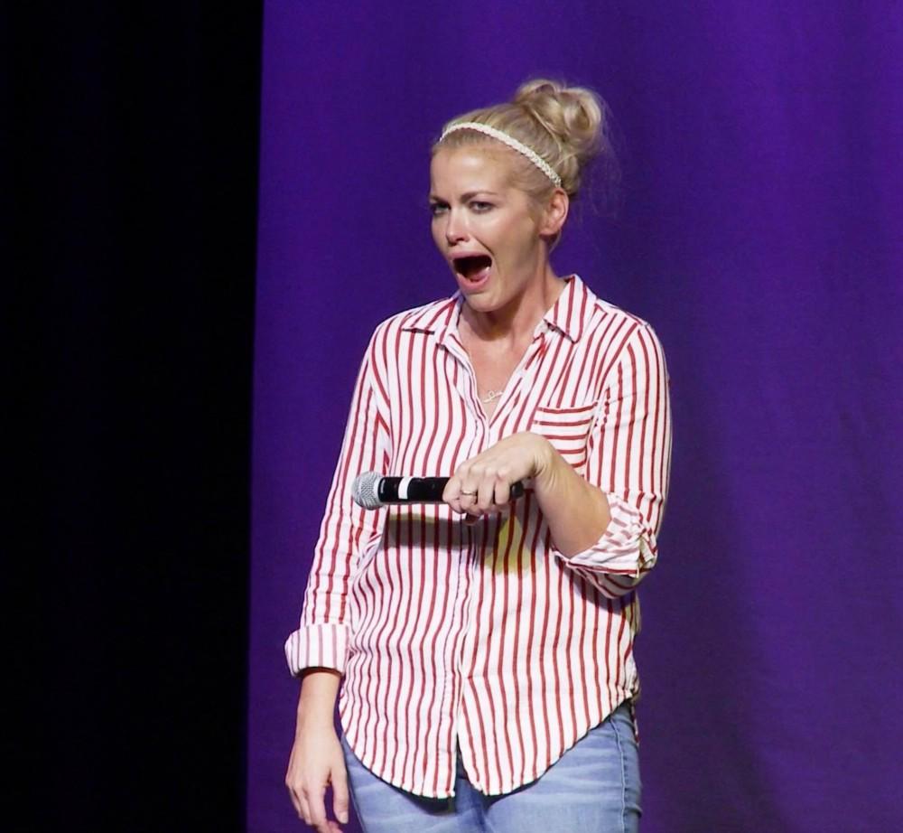 University of Arizona Alumna Aubree Sweeney on stage doing a comedy routine. Sweeney, based out of Los Angeles, does lots of traveling on the road as she goes on comedy tours and prepares for performances. 