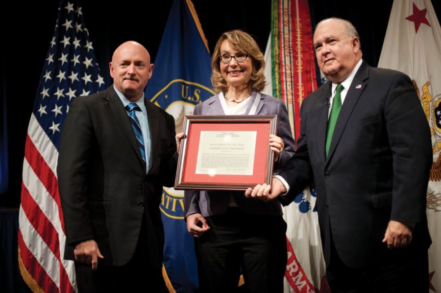 Under Secretary of the Army Joseph W. Westphal (far right) presents the Army Decoration for Distinguished Civilian Service to former Rep. Gabrielle Gabby Giffords (Ariz.) for outstanding public service and support of the Armys missions, Oct. 10, 2013 at the Pentagon, Washington, DC.  She is joined by her husband retired Navy Capt. Mark Kelly.  (U.S. Army photo by Staff Sgt. Bernardo Fuller)