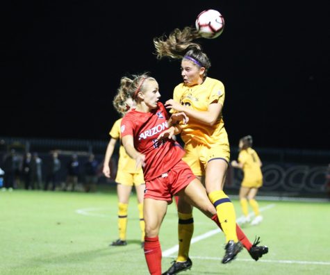 Midfielder Iliana Hocking (21) jumps to get the ball away from a Berkeley player during the game on Saturday, Oct. 13th at the Mulcahy Stadium in Tucson, Ariz. The game ended in a 3-3 draw.