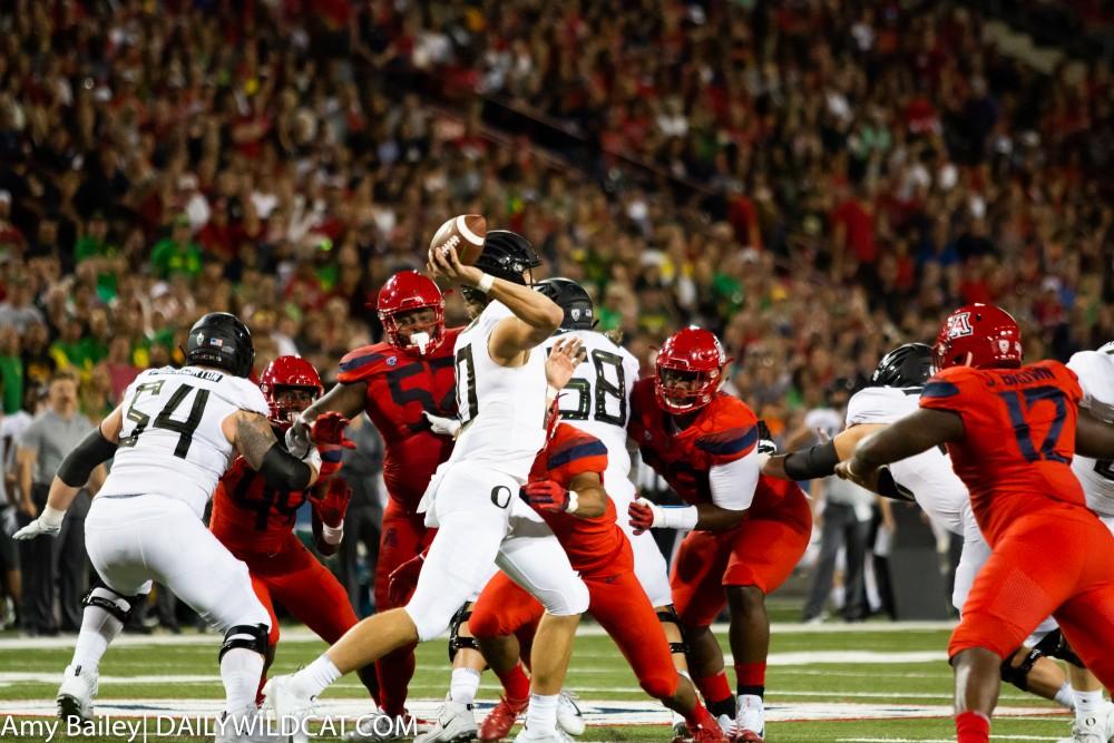 Wildcats rush to tackles Oregon's quarterback Justin Herbert (10) in the Arizona- Oregon game on Saturday Oct. 27, 2018 in Arizona Stadium in Tucson, Az.