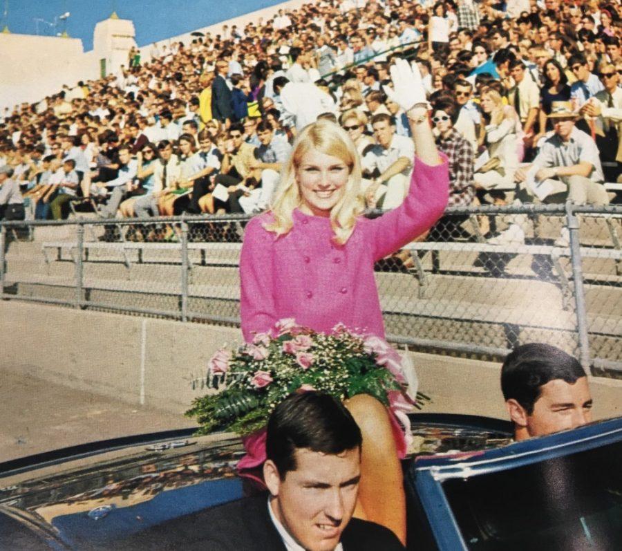 Homecoming Queen of 1968, Chris Belinn, waves to the crowd in the Arizona Stadium. Homecoming queen and king will be announced at the bonfire on Friday this year.