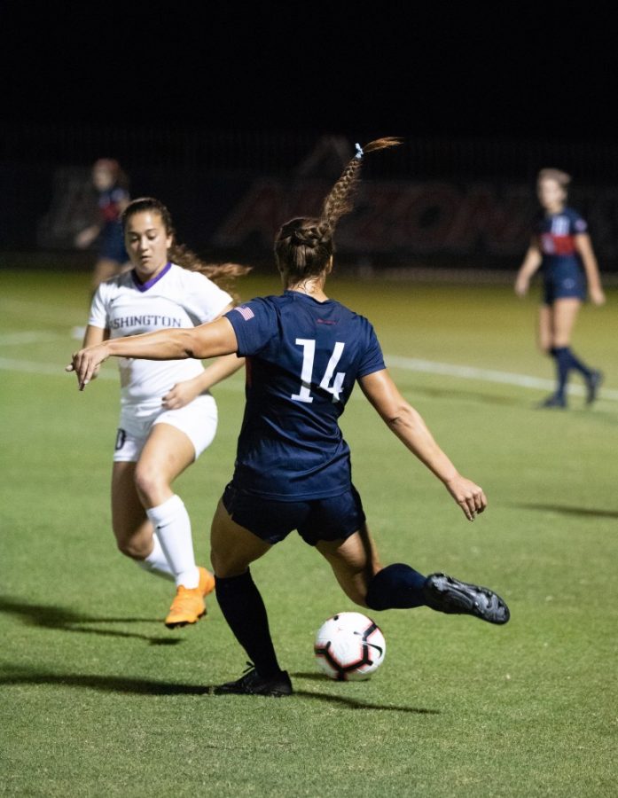 Arizona womens soccer player Jill Aguilera (14) kicks a power ball to a teammate from across the field in the Arizona-Washington game at Murphy Stadium on Thursday, October 18, 2018, in Tucson, AZ. The Wildcats won the game 1-0 in double overtime.