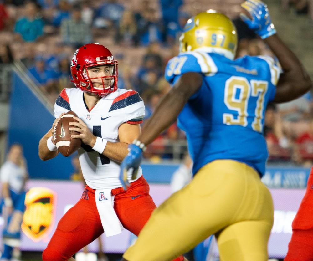 Quarterback Rhett Rodriquez (4) looks for an open player to pass the ball to during the Arizona v. UCLA game on Saturday, Oct. 20 at the Rose Bowl. 