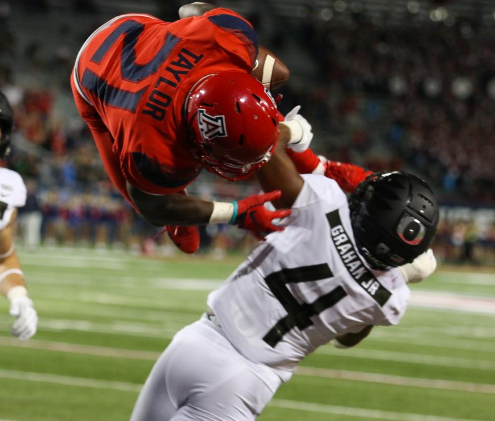 Running back JJ Taylor (21) flips into the end zone to score a touchdown for Arizona during the homecoming game against Oregon on Saturday, Oct. 27 at Arizona Stadium. The Cats defeated the Ducks 44-15. 