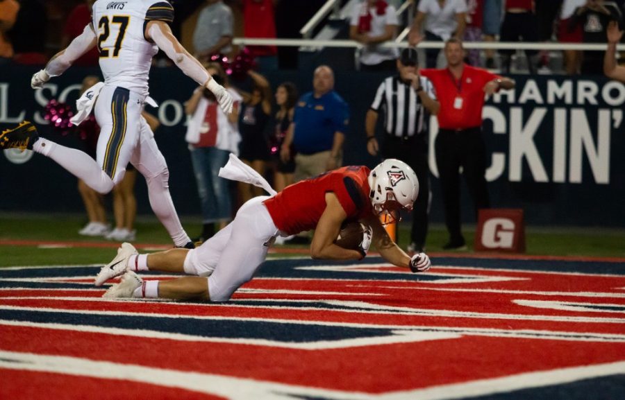 Wildcat Tony Ellison (9) dives into the end zone and scores the first touchdown of the UA-Cal Berkeley game at Arizona Stadium on Saturday October 6, 2018 in Tucson, Az.