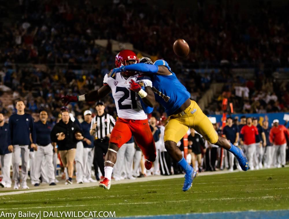 Arizona's J.J. Taylor (21) gets the ball knocked out of his hands during the second quarter of the Arizona-UCLA game at Spieker Field at the Rose Bowl in Pasadena, CA.