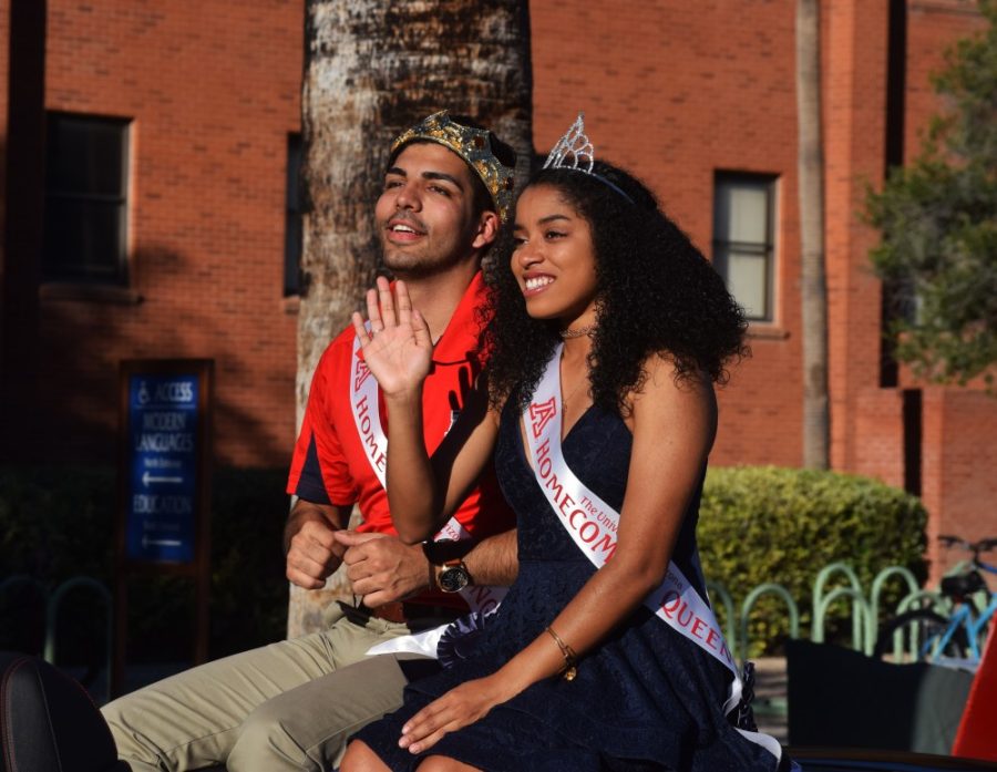 The King and Queen of Homecoming ride in the annual pride before the football game