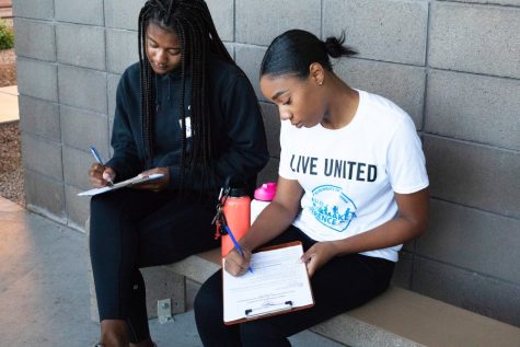 Eller African American Honary's Brianna Boitano and Amirah Williams sign their waivers before entering the pound at the Pima Animal Care Center for Eller Make A Difference Day. Saturday, October 20, 2018, in Tucson AZ.