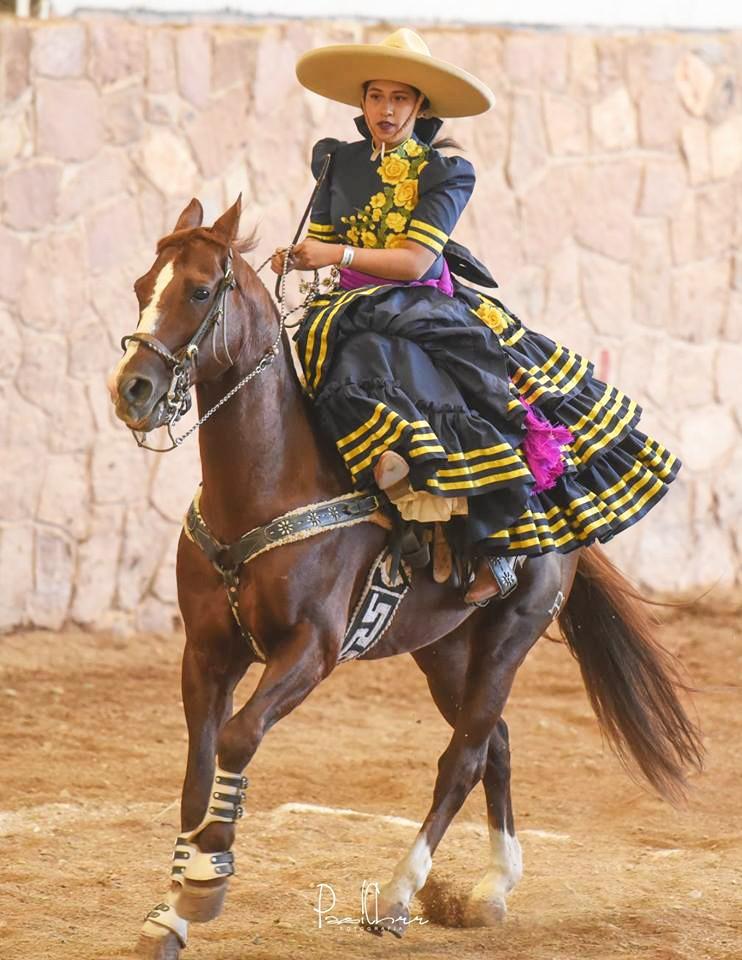 Maria Fernanda Osornio, rides her horse during a performance for her escaramuzas team. The escaramuzas are girls who ride sidesaddle on horses while they perform choreography to music.  