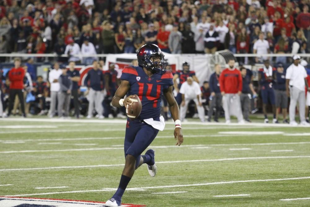 Arizona quarterback Khalil Tate (14) runs with the ball, looking for a teammate during the first quarter of the Arizona vs. Colorado game on Friday November 2, 2018. Wildcats lead 26-24 at halftime.