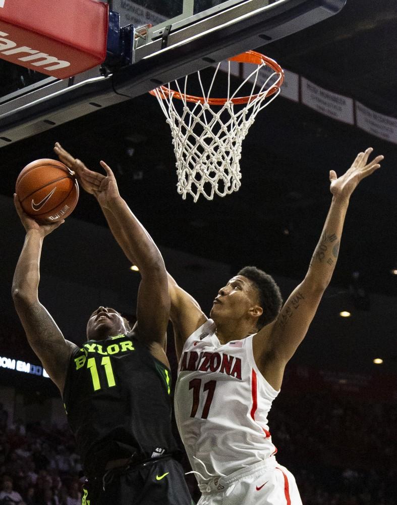 Arizona's Ira Lee (11) blocks a shot from Baylor's Mark Vital (11) during the Arizona-Baylor game on Saturday, Dec. 15 at the McKale Center in Tucson, Ariz.