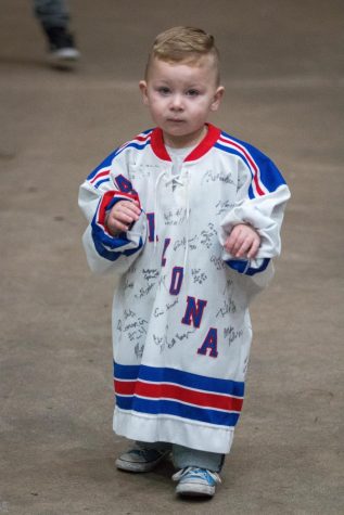 A young Arizona Wildcat fan awaits the players to come out of the locker after the second period of play against Arizona State on November 31st.