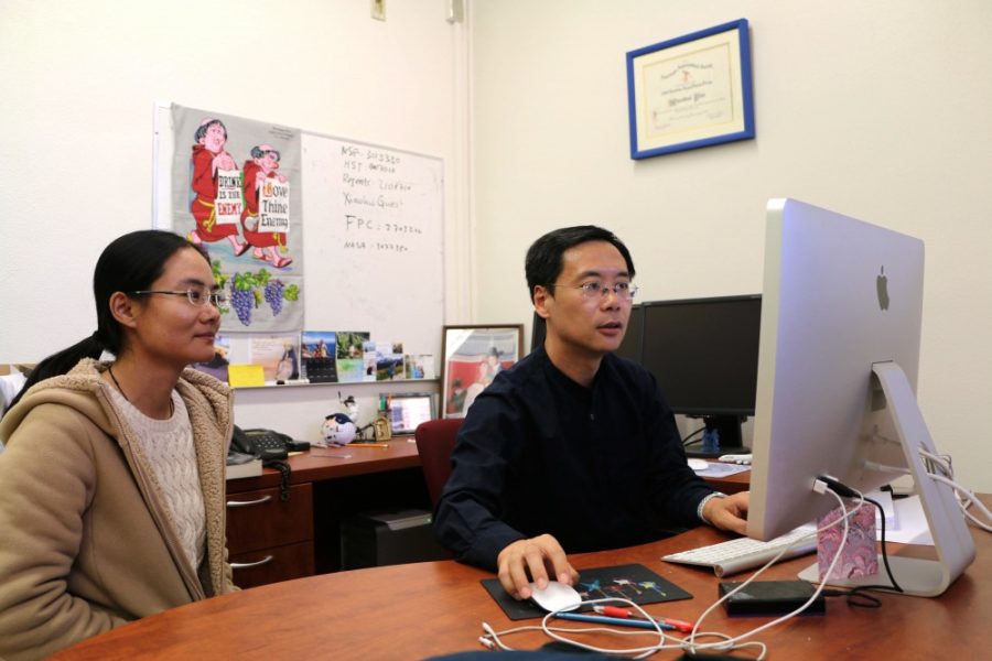 Xiaohui Fan, a regents’ professor of astronomy at UA, and his post-doctoral researcher, Jinyi Yang, look over data collected from the Hubble Space Telescope of a quasar they discovered while observing the early universe. 
