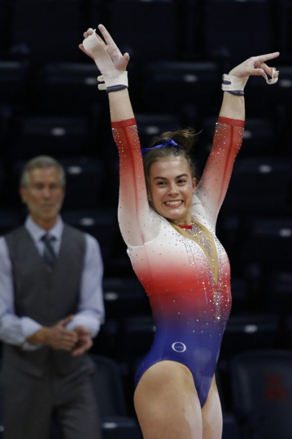 UA gymnast Maddi Leydin salutes the judges after completing her routine on the uneven bars during the UA v California meet on Jan. 26 in McKale Center.