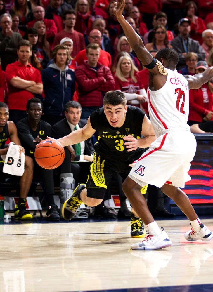 Justin Coleman (12) tries to block Oregon's offense during the beginning of the Arizona-Oregon basketball game. 
