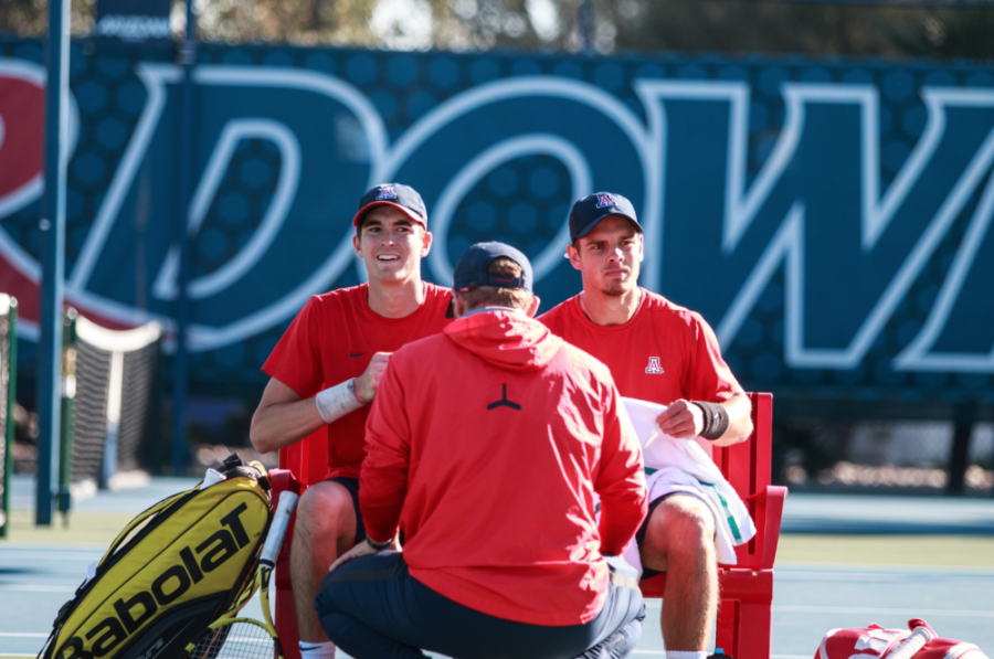 The Arizona mens tennis team sits on the sidelines as they get ready to play their next set at the Robson Tennis Center.